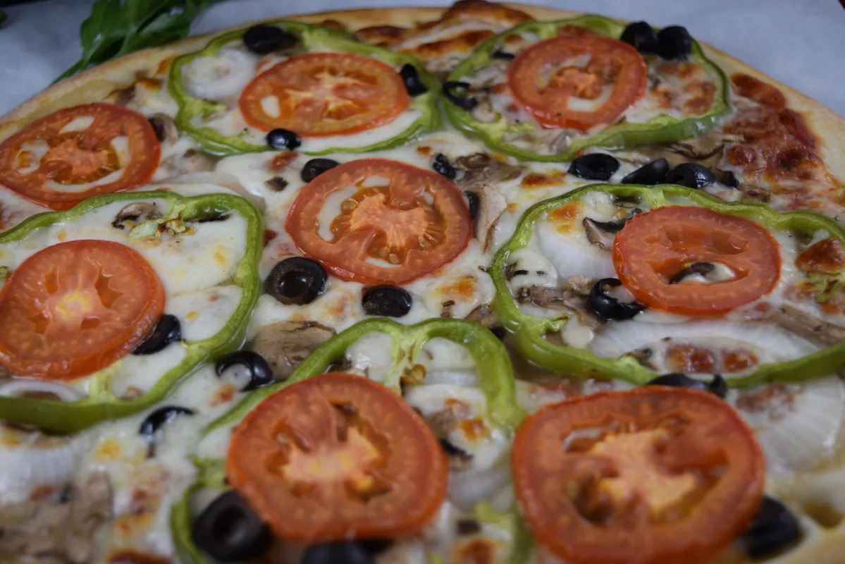 green pepper, tomato, olive and mushroom pizza